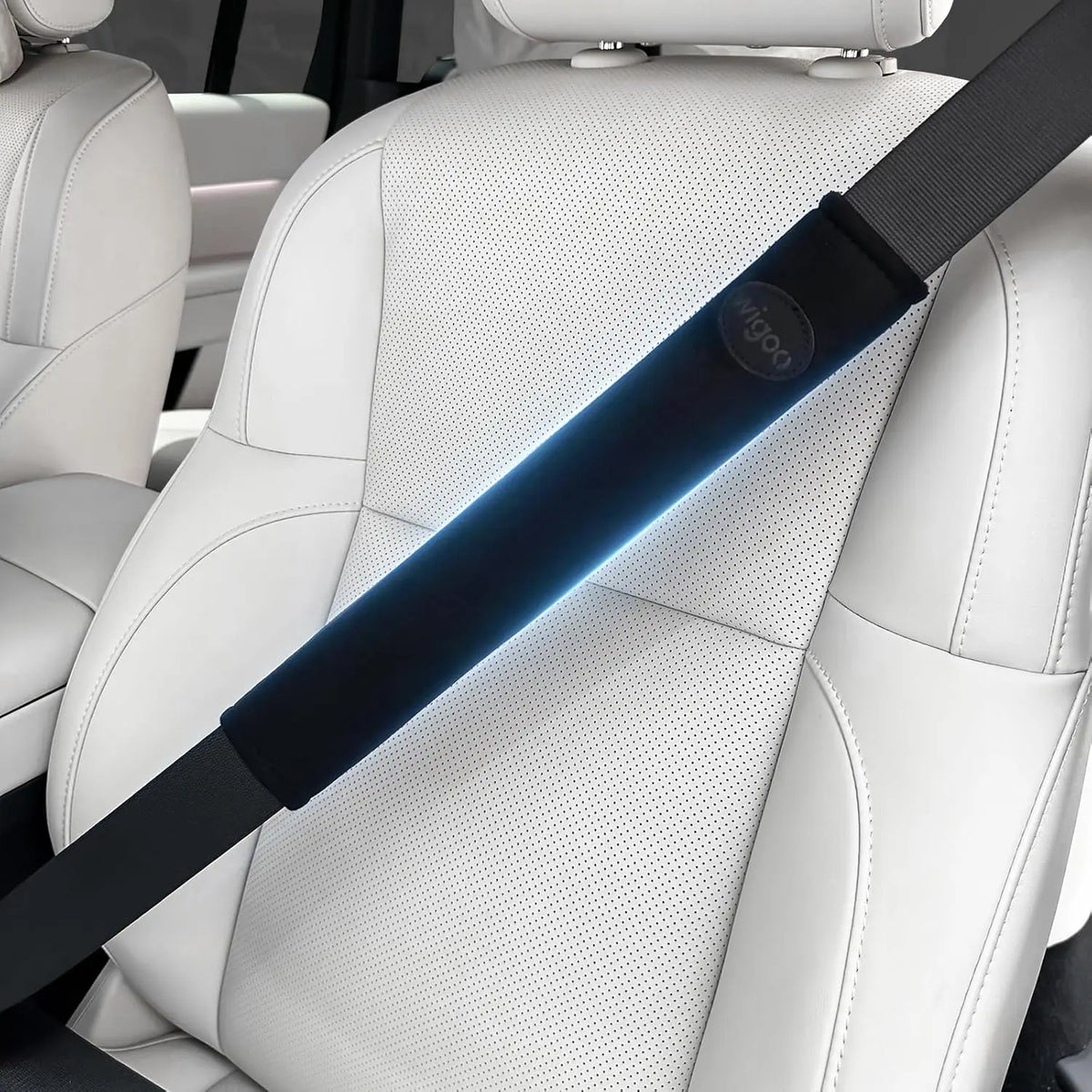 Car seat with a black seat belt on a white interior background