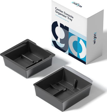 Two gray center console organizer trays with a branded box in the background.