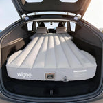 Inflatable mattress in the trunk of a car with wigoo branding.