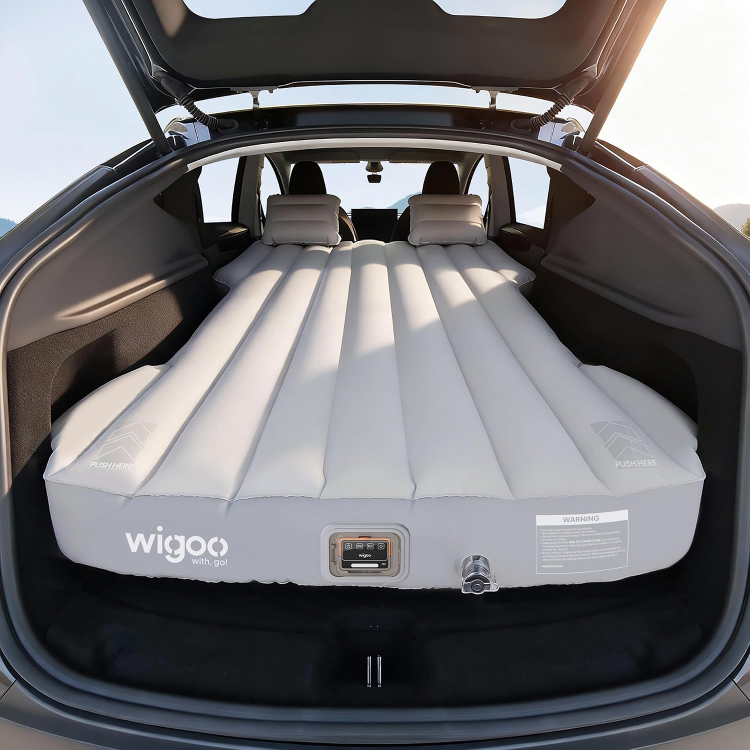 Inflatable mattress in the trunk of a car with wigoo branding.