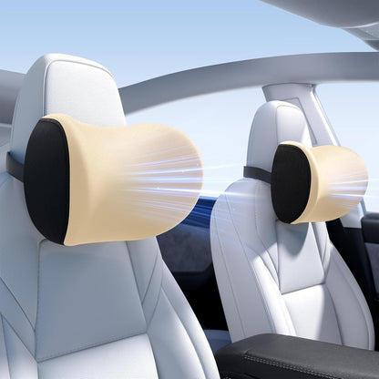Car headrest pillows with beige cushions and black straps installed in a vehicle.