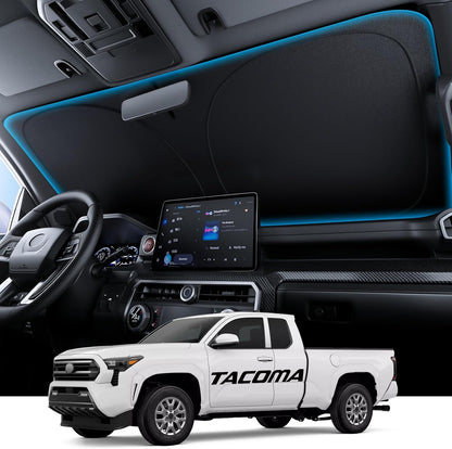 Car interior with dashboard display and a white Toyota Tacoma truck below.