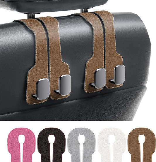 Car seat hook with brown leather straps and metal hooks on a car seat.